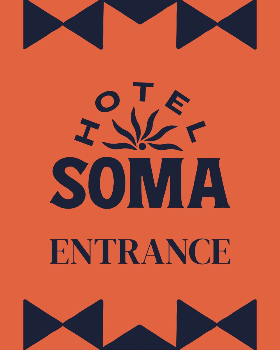 Hotel SOMA entrance sign: agave mark and wordmark in navy on orange, with triangle borders